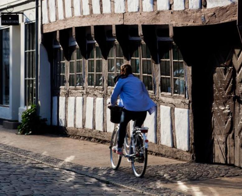 Cycling down an old street in Odense, Denmark