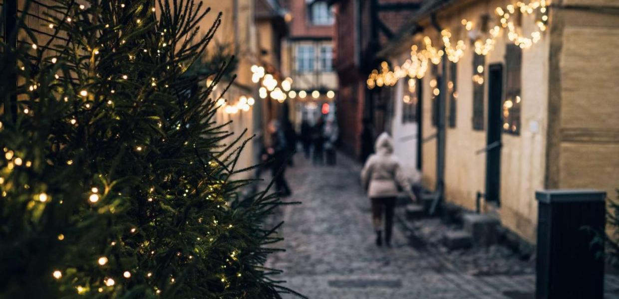 A cobbled street in Odense lit with Christmas lights