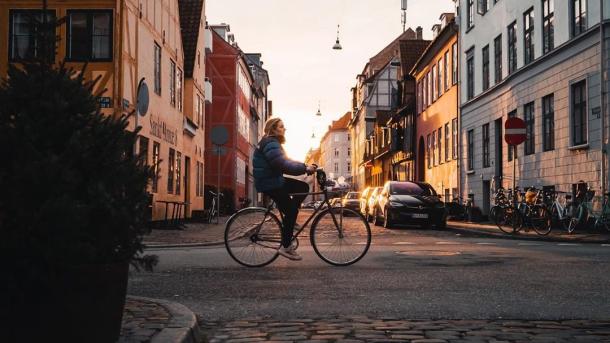 Girl biking in the neighbourhood of Christianshavn in Copenhagen